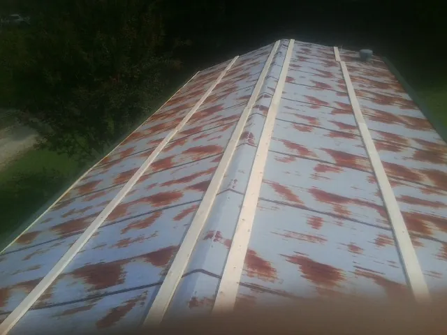 Rusted metal roof panels with new wood purlins before replacement — Storm Damage Roof Repair in Tenafly by Roofing Brothers