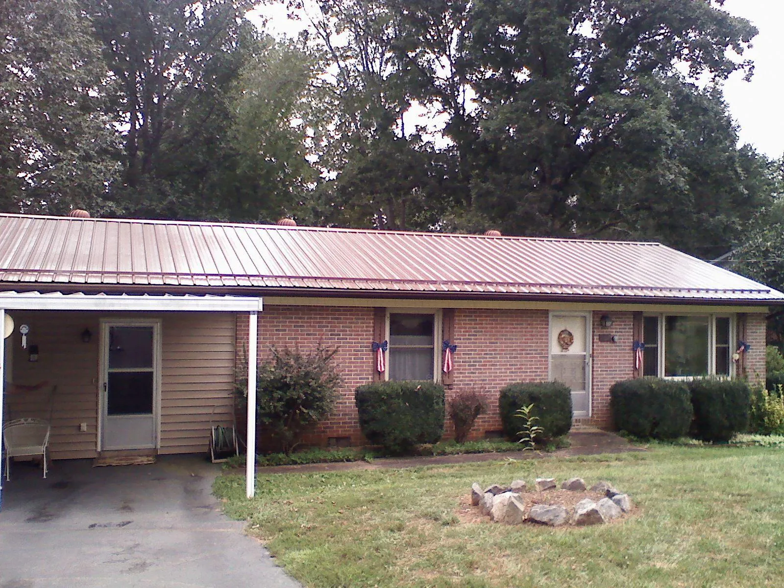 Bronze metal roof and carport on a brick ranch home — Roof Repair work by our crew in Tenafly