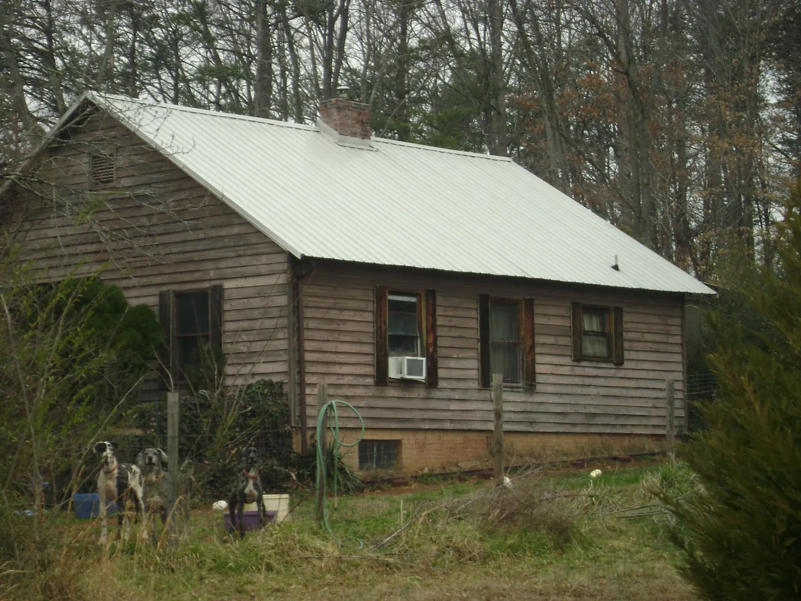White metal roof on an old wood sided farmhouse, from a Metal Roof Installation job in Tenafly